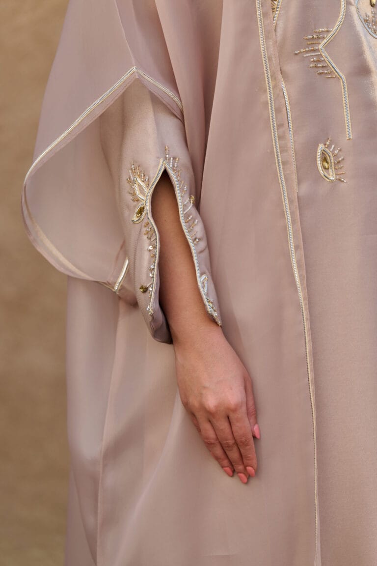 Hand embroidery detail on an OSH jalabiya